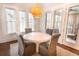 Bright dining area with round table, gray chairs, and large windows providing ample natural light at 1445 Lettered Olive Ln, Mount Pleasant, SC 29464