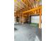Spacious garage with a golf simulator, gym equipment, and black rubber flooring at 1445 Lettered Olive Ln, Mount Pleasant, SC 29464