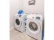 A laundry room with white washer and dryer and decor at 1445 Lettered Olive Ln, Mount Pleasant, SC 29464
