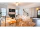 Bright living room with fireplace, hardwood floors, and comfortable seating arrangement at 1445 Lettered Olive Ln, Mount Pleasant, SC 29464