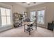 Bright home office with natural light, shelving, and neutral colored carpet at 1445 Lettered Olive Ln, Mount Pleasant, SC 29464