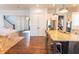 Open concept kitchen with stainless steel appliances and hardwood floors overlooking the living area at 1445 Lettered Olive Ln, Mount Pleasant, SC 29464