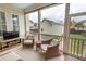 Cozy screened porch with comfortable seating and a view of the backyard pool area at 1445 Lettered Olive Ln, Mount Pleasant, SC 29464