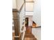 Staircase with hardwood steps and white risers, offering a view of the open floor plan at 1445 Lettered Olive Ln, Mount Pleasant, SC 29464