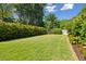 Large, luscious backyard with a trimmed fence and beautiful green grass at 1474 Indian St, Mount Pleasant, SC 29464