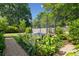 Backyard featuring a trampoline, stone paths and mature landscaping in a private backyard setting at 1474 Indian St, Mount Pleasant, SC 29464