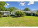Green backyard featuring a trampoline, lush greenery, and a lovely home at 1474 Indian St, Mount Pleasant, SC 29464