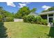 The backyard features lush greenery, a trimmed fence, and bright skies at 1474 Indian St, Mount Pleasant, SC 29464