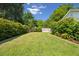 The backyard has a trimmed fence with bright green grass and blue skies at 1474 Indian St, Mount Pleasant, SC 29464