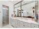 Bright bathroom featuring double marble vanity, large mirror, and glass-enclosed shower providing a spa-like experience at 1474 Indian St, Mount Pleasant, SC 29464