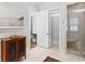 View of bathroom with vanity, framed beach art, and doors to a toilet room and marble shower with bench seat at 1474 Indian St, Mount Pleasant, SC 29464