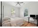 Bright bedroom with wood floors, ceiling fan, and natural light from the windows at 1474 Indian St, Mount Pleasant, SC 29464