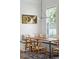 Close-up of dining area featuring rustic wooden table, stylish chairs and modern art at 1474 Indian St, Mount Pleasant, SC 29464