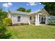 Charming home exterior features a porch swing and well-manicured lawn at 1474 Indian St, Mount Pleasant, SC 29464