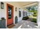 Welcoming front porch with orange door, stylish planters, and good lighting at 1474 Indian St, Mount Pleasant, SC 29464