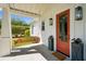Charming front porch with a swing, stylish lighting, and orange door at 1474 Indian St, Mount Pleasant, SC 29464