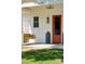 Inviting front porch features a porch swing and orange front door at 1474 Indian St, Mount Pleasant, SC 29464