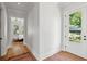 Bright hallway with hardwood floors leading to a bedroom and an outdoor entrance at 1474 Indian St, Mount Pleasant, SC 29464