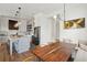 Modern kitchen and dining area with hardwood floors, stainless appliances, and large island at 1474 Indian St, Mount Pleasant, SC 29464