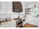 Modern kitchen featuring stainless steel appliances, white cabinets, and marble countertops at 1474 Indian St, Mount Pleasant, SC 29464