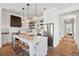 Kitchen featuring island with bar seating, stainless appliances, and white cabinetry at 1474 Indian St, Mount Pleasant, SC 29464