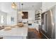 Kitchen with a large island, pendant lights, and stainless steel appliances with views into the living room at 1474 Indian St, Mount Pleasant, SC 29464