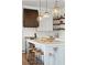 Close-up of the kitchen island with pendant lights, marble countertop, and wooden stools at 1474 Indian St, Mount Pleasant, SC 29464