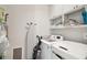 Functional laundry room with washer, dryer, shelving, and ample storage at 1474 Indian St, Mount Pleasant, SC 29464