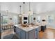 Open-concept living area boasts hardwood floors, modern lighting, fireplace, and stylish furnishings at 1474 Indian St, Mount Pleasant, SC 29464