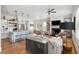 Open-concept living room and kitchen with hardwood floors, fireplace, and ample seating creates an inviting space at 1474 Indian St, Mount Pleasant, SC 29464