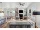 Bright living room features a decorative fireplace and seamless transition to the dining area at 1474 Indian St, Mount Pleasant, SC 29464
