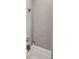 Close up of shower walls tiled with light gray horizontal tiles with a mounted shower head at 1474 Indian St, Mount Pleasant, SC 29464