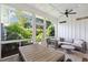 Bright sunroom with outdoor views, comfortable seating, and ceiling fan at 1474 Indian St, Mount Pleasant, SC 29464