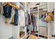 Organized walk-in closet with built-in shelving and hanging rods for clothes and shoes at 1474 Indian St, Mount Pleasant, SC 29464