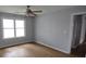 Bright bedroom with a ceiling fan, large windows, and wood-look flooring at 148 Lancashire Rd, Summerville, SC 29486