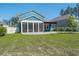 A charming blue two-story home features a lovely screened porch and spacious backyard with a cozy pergola at 176 Clearblue Loop, Summerville, SC 29486