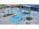 An aerial view shows the luxurious community pool, complete with palm trees, lounge chairs, and inviting turquoise waters at 176 Clearblue Loop, Summerville, SC 29486