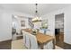 Bright dining room with a rustic table and elegant white chairs at 176 Clearblue Loop, Summerville, SC 29486