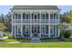 Charming two-story blue home featuring a double porch and a manicured lawn at 176 Clearblue Loop, Summerville, SC 29486