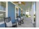 Inviting front porch with rocking chairs, ceiling fans, and decorative plants at 176 Clearblue Loop, Summerville, SC 29486