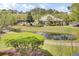 Scenic aerial view of property featuring pond with fountain and exterior of community clubhouse at 2014 Basildon Rd, Mount Pleasant, SC 29466