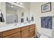 Well-lit bathroom with wooden cabinets, a large mirror, and a shower with glass doors at 2014 Basildon Rd, Mount Pleasant, SC 29466