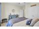 Serene bedroom showcasing a comfortable bed, blue dresser, and plenty of natural light from the window at 2014 Basildon Rd, Mount Pleasant, SC 29466