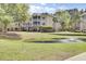 Exterior of the building featuring multi-story architecture, balconies, pond views, and well-maintained grounds at 2014 Basildon Rd, Mount Pleasant, SC 29466