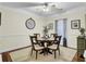 Elegant dining room with a round wooden table, seating for four, and natural light from the window at 2014 Basildon Rd, Mount Pleasant, SC 29466