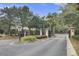 Community entrance with brick pillars, iron gates, lush landscaping, and signage for directions and information at 2014 Basildon Rd, Mount Pleasant, SC 29466