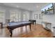 Community game room with pool table, foosball, a mounted television, and hardwood floors at 2014 Basildon Rd, Mount Pleasant, SC 29466