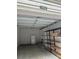 Spacious garage featuring storage shelves, a rolling chair and a refrigerator at 2014 Basildon Rd, Mount Pleasant, SC 29466