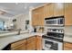 Kitchen with stainless steel appliances, wood cabinets, and open view to the living area at 2014 Basildon Rd, Mount Pleasant, SC 29466