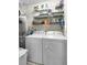 Functional laundry room with washer, dryer, water heater, and shelving for storage at 2014 Basildon Rd, Mount Pleasant, SC 29466